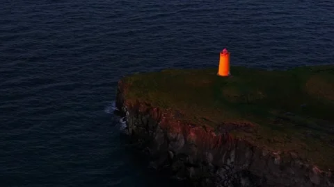 Static aerial view of Yellow lighthouse in perfect sunset light Stock Footage 330896235