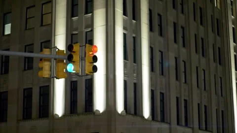 Static anamorphic shot of traffic lights changing from red to green in downtown Stock Footage 296036610