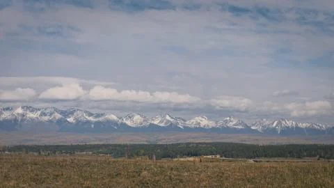 Static background on close-up powerful mountains. Dry steppe, mighty snow-capped Stock Photos