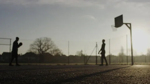 Static blurred background shot of two people shooting a basketball on an outdoor Stock-Footage 231347998