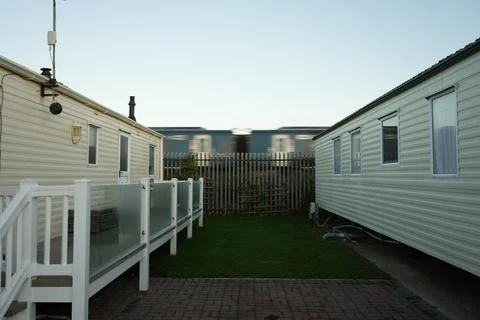Static Caravans And Blurred Train At Holiday Park In Towyn, North Wales. Stock Photos