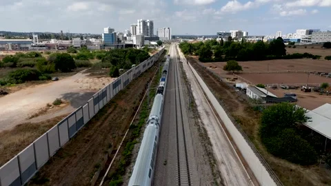 Static Cinematic Drone Shot Hovering Above Railway Tracks as Passenger Train Stock Footage 338040604