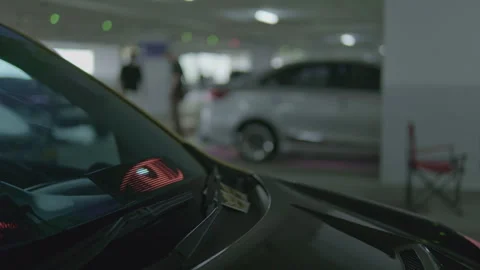 Static cinematic shot of car windshield with blinking red LED eye display Stock Footage 345654063