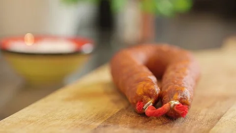 A static close up of chorizo on a chopping board defocussed background Stock Footage 79836043