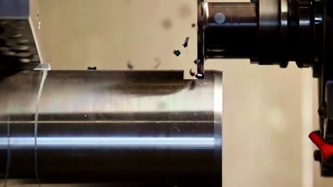 Static close up of CNC lathe machine turning metal cylinder with flying chips Stock Footage 331930099