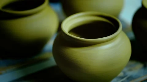 Static close-up of finished raw clay pots drying in a workshop. Stock Footage 328925538