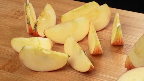 Static Close Up Fresh Apple Wedges On Wooden Cutting Board 4K Stock Footage 321868467
