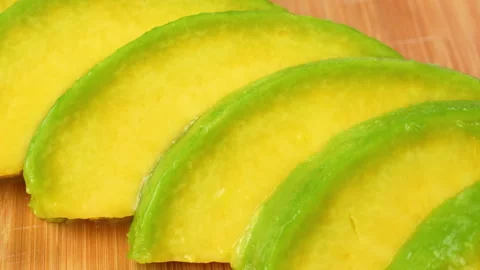 Static Close Up Fresh Avocado Slices On Wooden Board 4K Stock Footage 322085627