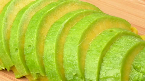 Static Close Up Fresh Avocado Slices On Wooden Board 4K Stock Footage 322085650