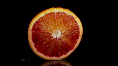 Static Close-Up of Juicy Cut Red Sicilian Orange with Dripping Water and Reflect Stock Footage 312148528