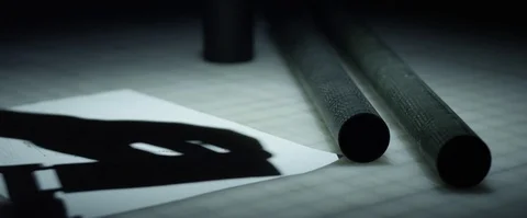 Static Close Up of man measuring carbon fiber tubes on a workbench. Stock Footage 85288779