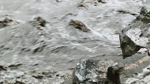 Static close up shot of rocks in murky river rapids Stock Footage 153802153