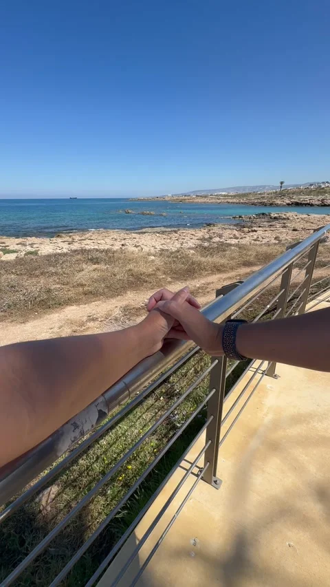 Static close up shot of a romantic couple holding hands on a balcony railing Stock Footage 336219182