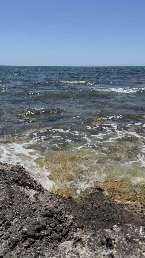 Static close up shot of sea waves splashing on volcanic coastal rocks Stock Footage 336320347