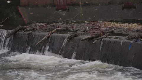 A static close-up shot of white water cascading over the concrete edge of a 스톡 동영상 326421180