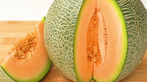 Static Close Up Sliced Fresh Green Netted Melon Revealing Orange Flesh 4K Stock-Footage 323081712