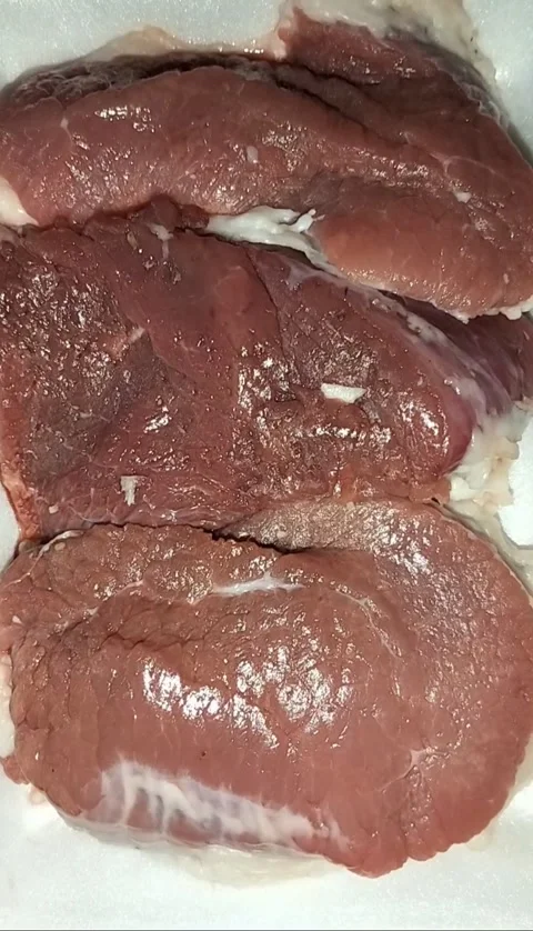 Static Close-up of Three Raw Red Meat Steaks on White Foam Tray Stock Footage 323103069