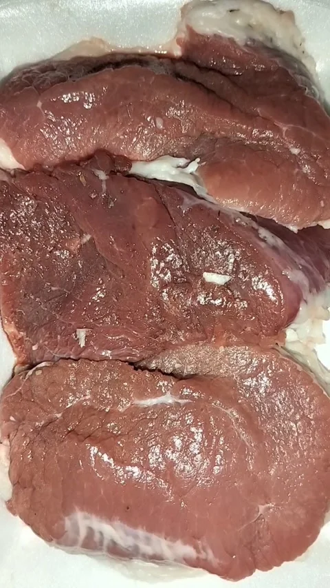 Static Close-up of Three Raw Red Meat Steaks on White Foam Tray Stock Footage 323103070