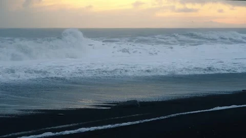 Static close-up of waves crashing on black sand beach at sunset, Iceland. H.. Stock Footage 327683798