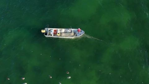 Static closeup aerial view looking down on two men pulling in fishing nets. Stock Footage 104683918