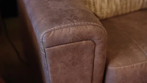 Static Closeup of Rustic Brown Leather Sofa Corner Showing Baseball Stitch Stock Footage 307834721