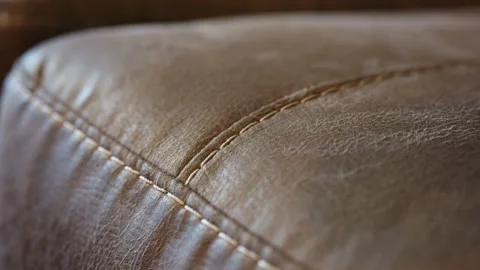 Static Closeup of Thick White Baseball Stitching on Rustic Brown Leather Sofa Stock Footage 308355009