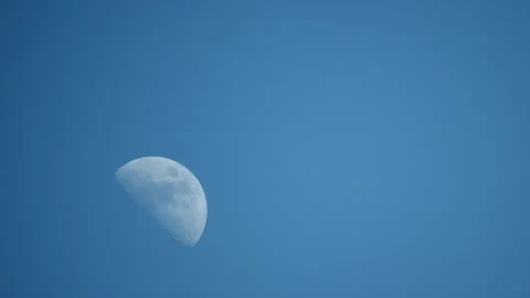 Static colorfull view of the growing moon in the blue daytime sky. Stock Footage 194514836