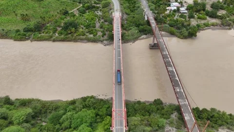 Static drone angle of red bridge with truck crossing. Stockbeeldmateriaal 333865558
