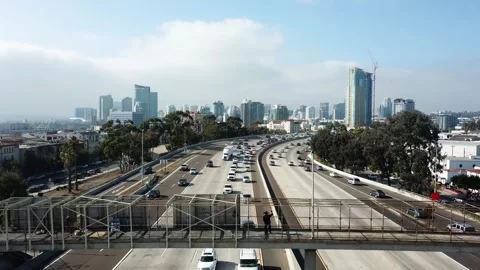 Static drone shot at 3PM of a dancing subject on a bridge with downtown San Video stock 333615883