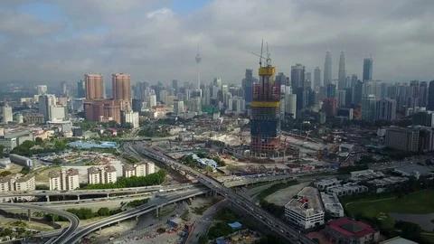 Static drone shot of major intersection, construction site, skyline Kuala Lumpur Stock Footage 78454975