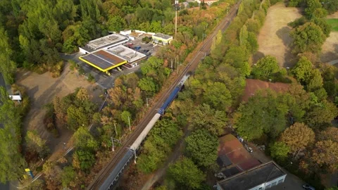 Static drone shot of a passenger train in a park Stock Footage 254332145