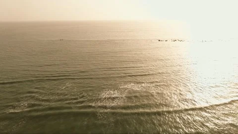 Static drone shot with slow pan over calm ocean waves at Cap Skirring, Casamance Stock Footage 309913703