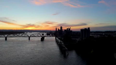 Static drone shot of a train bridge over The Columbia River at sunset in Stock Footage 328388621