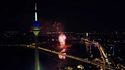 Static drone shot with a view of the Rhine Tower and the fireworks display. 스톡 동영상 220339352