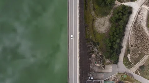 Static drone view from above of a road over a dam wall Stock Footage 255849661