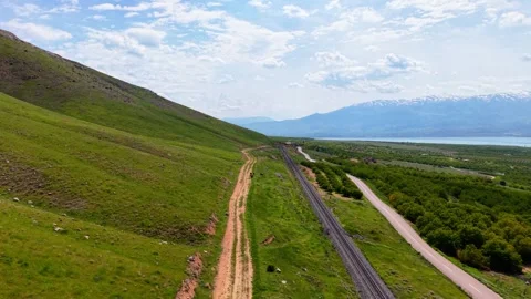 Static Elevated Shot of Green Mountain Road with Dirt Path and Railway, 4K 60fps Stock-Footage 336863073
