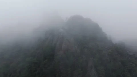 Static footage of clouds moving over mountain peak Video stock 278487957