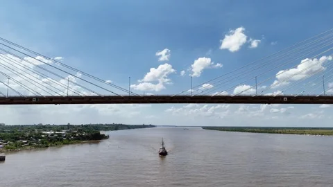 Static front view of vessel passing under Rosario-Victoria suspension bridge Stock Footage 328667919