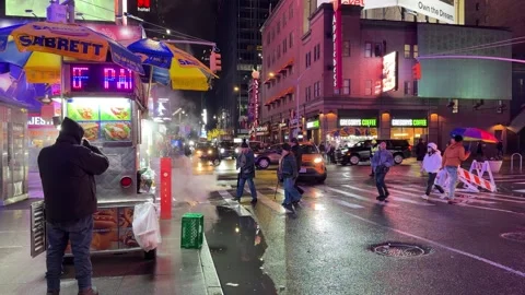 Static Handheld Of Street Vendor And Dancers On Wet Crosswalk, New York Night Vídeo Stock 342653674
