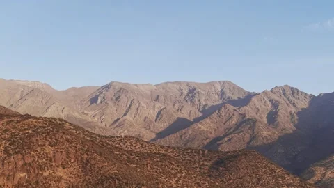 Static high-angle aerial view of the rugged Andes mountain peaks under a clear Stock Footage 333285058