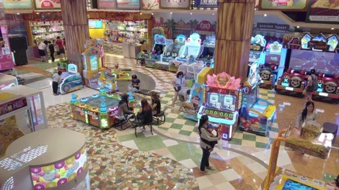 Static high angle shot of a section of an indoor arcade center. Women Video stock 227273286
