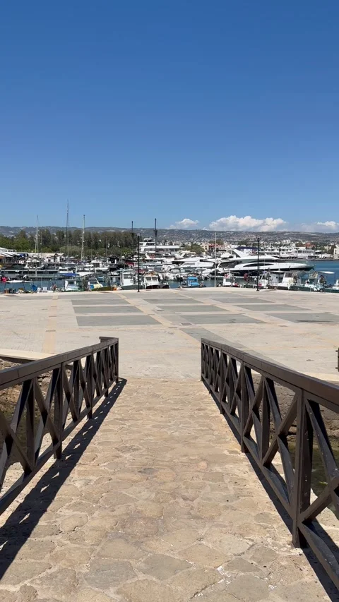 Static high angle view from a bridge overlooking a concrete pier walkway Stock Footage 336278774