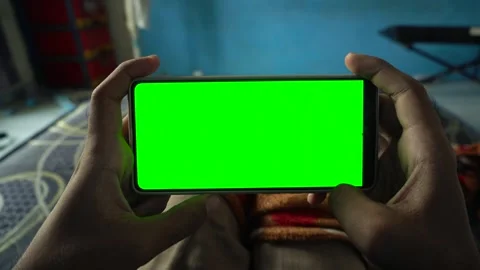 Static horizontal smartphone display with a green screen held by a person i.. Stock Footage 340490874