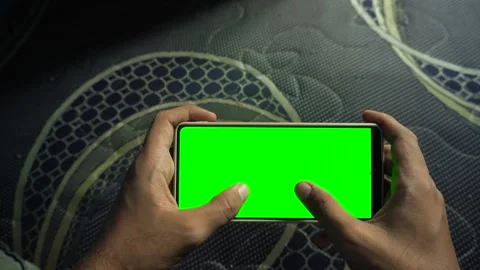 Static horizontal smartphone display with a green screen held by a person p.. Stock Footage 340490901