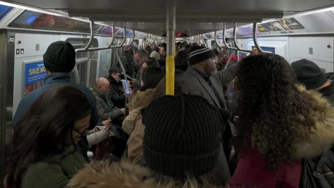 A static interior shot of a New York City subway car crowded with commuters Stock Footage 296272105