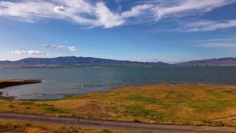 Static Lakeside Steppe with Golden Dry Grass and Gentle Blue Water Stock-Footage 339764290