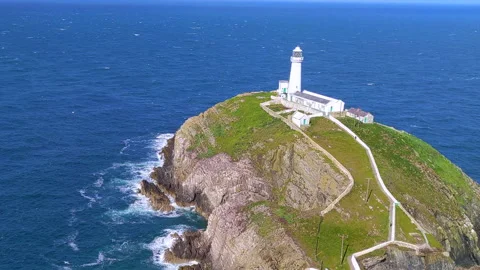 Static - Lighthouse, blue sky, windy weather, bird sanctuary, crashing waves Stock Footage 198225289