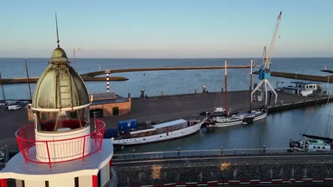Static lighthouse side with ladder railing and harbor beyond Stock Footage 331842060