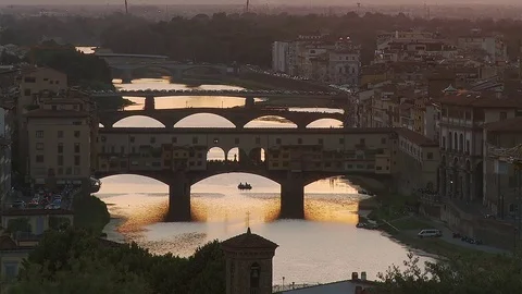Static long shot of the Ponte Vecchio Florence at sunset, Italy Stock Footage 74802336