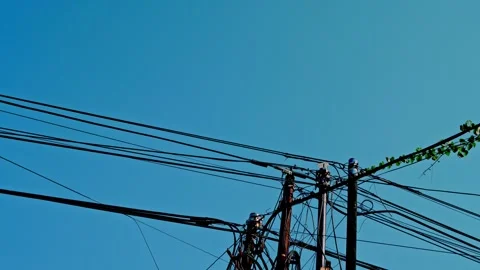 Static low angle shot looking up at electric utility poles and tangled powe.. Stock Footage 342030415